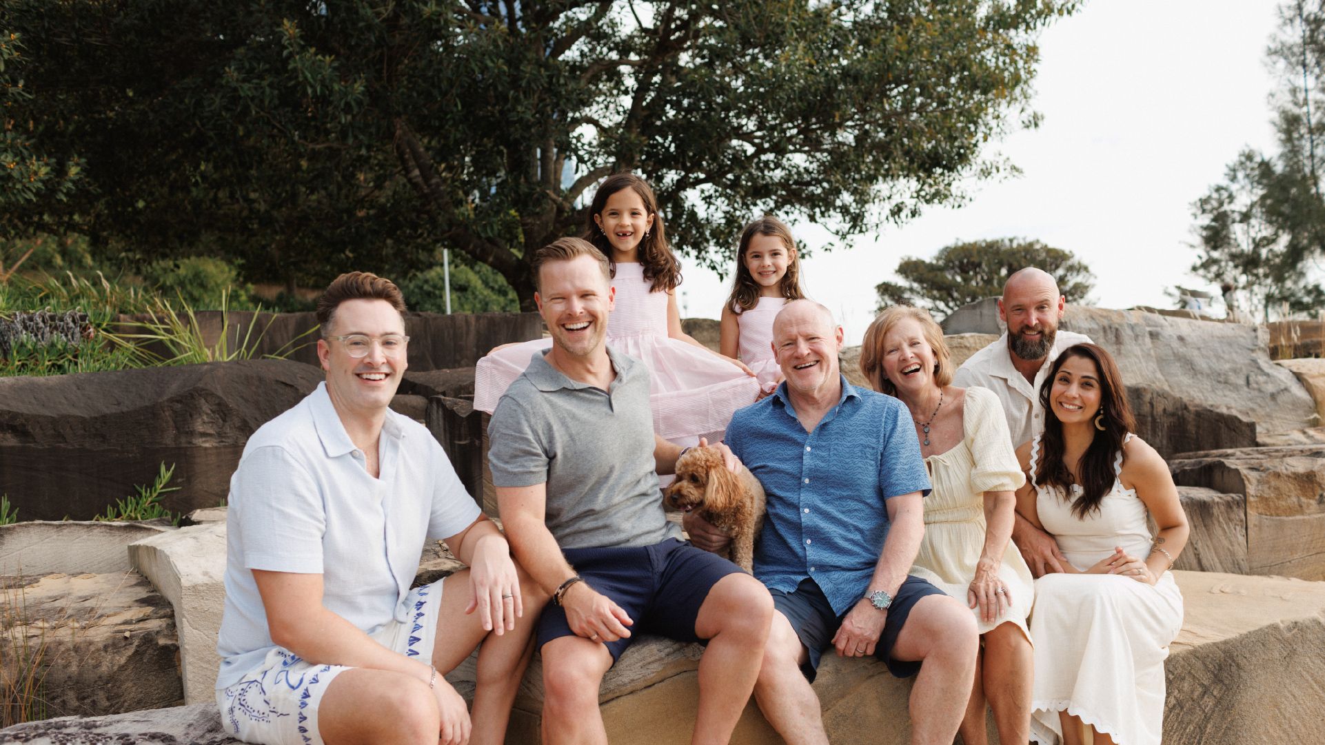 Our gift in Will supporter, Pam, and her intergenerational family sitting at the beach